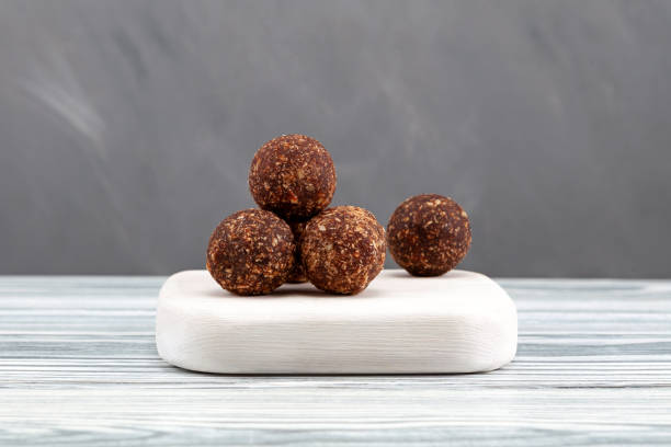 istock Alternative fruit candy sugar free. Healthy sweets for Ramadan menu. Energy balls with dried date fruits, honey, nuts and carob powder. Vegetarian round candies 1460025526