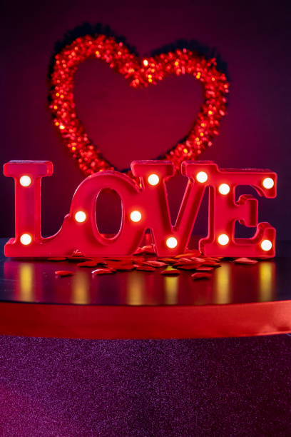 istock Valentine's Day luminous LOVE written on a plane with hearts 1460025888