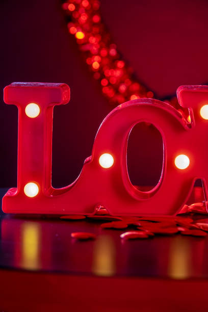 istock Valentine's Day luminous LOVE written on a plane with hearts 1460025889