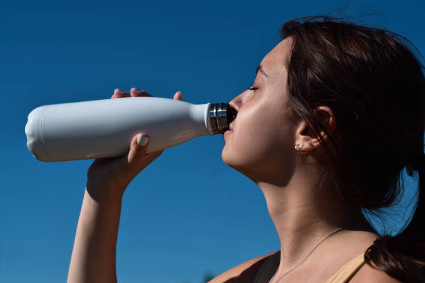istock Young woman drinking water during outdoor workout 1460025892