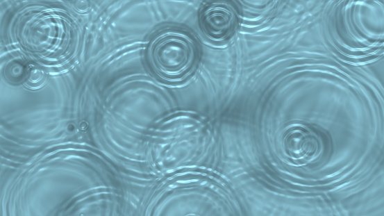 Concentric raindrop waves on water surface top view