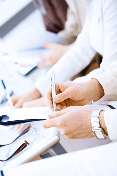 istock Line of people with notebooks and pens writing notes 146002692