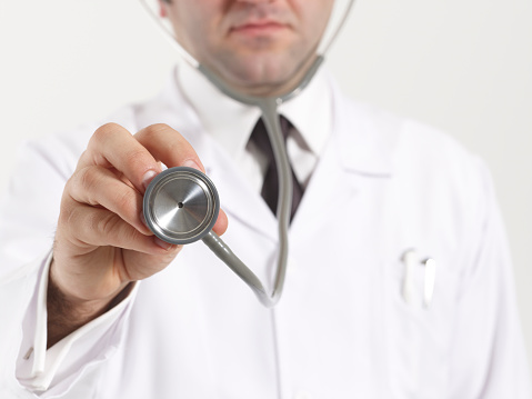 Detail of a doctor handling his stethoscope