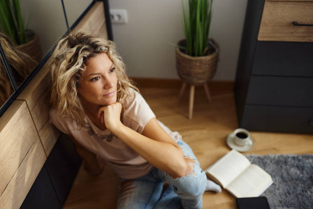 istock Young woman day dreaming at home. 1460028557