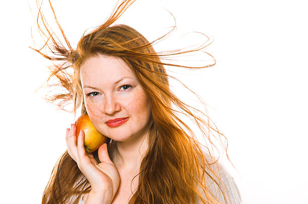 The beautiful girl with an apple stock photo