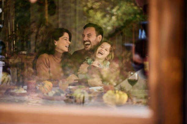 istock Cheerful parents having fun with their daughter at dining table. 1460030303