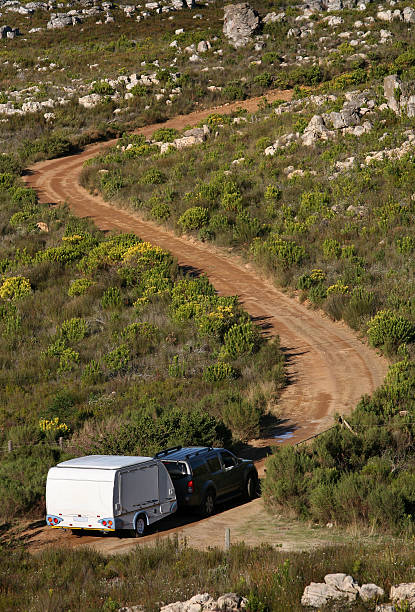 caravan on dirt road stock photo