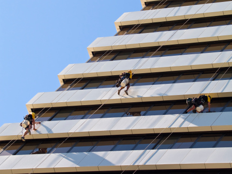 Window cleaners dangling off a skyscraper