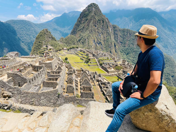 istock Young man looking at Machu Picchu ancient city, Peru 1460031946