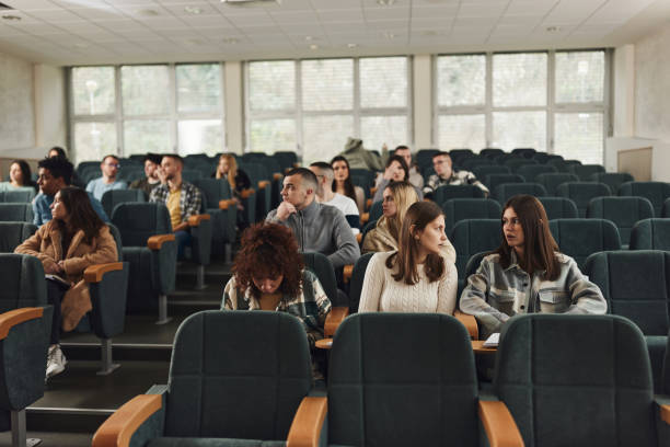 istock Large group of college students in a lecture hall. 1460032196