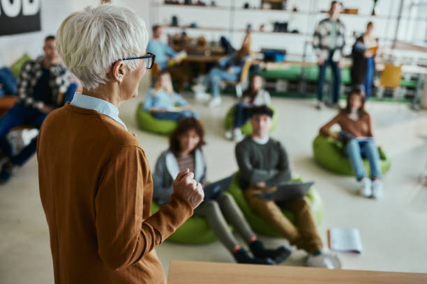 istock Mature female professor giving a lecture in a modern classroom. 1460033186