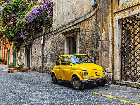 Small Yellow Car Parked on a Roman Street