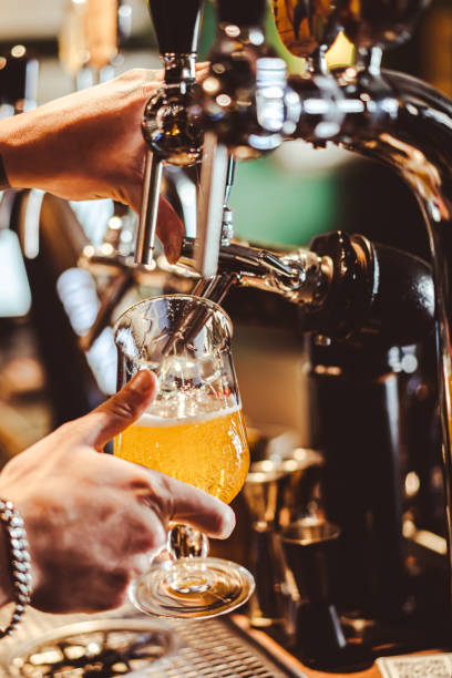 istock Bartender filling beer from tap at bar 1460034894