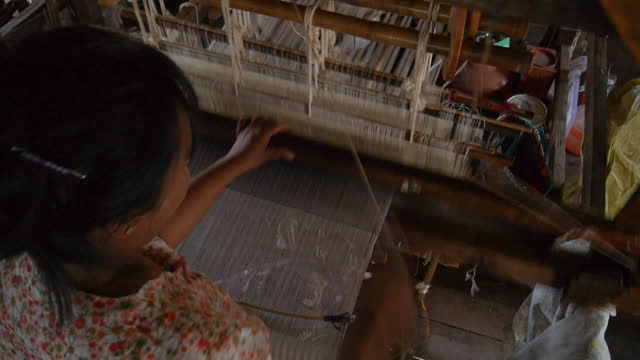 Woman weaving on a traditional loom