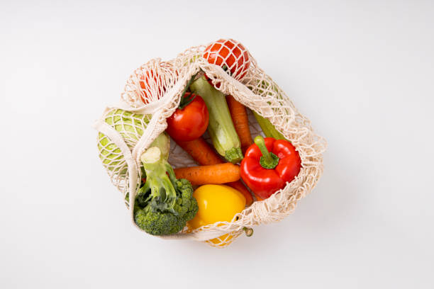 istock Fresh vegetables in a bag on a white table. Top view, flat lay. Banner 1460038811