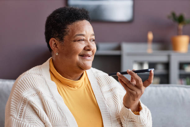 istock Black senior woman recording voice message 1460038850