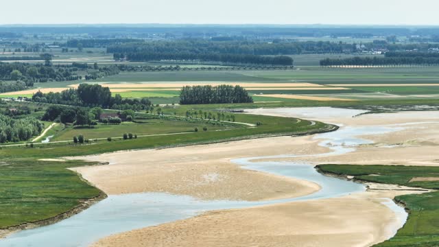 Lake and river flowing through green polder landscape at Netherlands and Belgium border, Het Zwin nature reserve