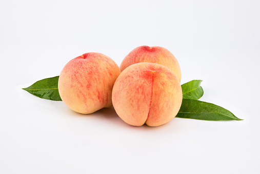 Ripe organic peaches few ripe organic peaches on a light pink background. Top view on a light pink background. Top view