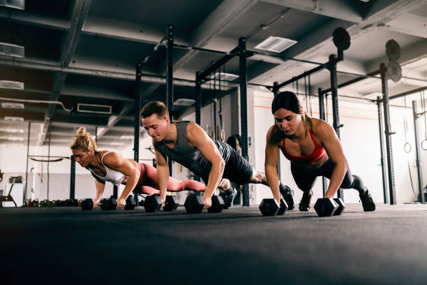 istock Athletes exercise together at the gym, with weights 1460040209