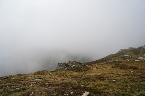Drop in the fog over the Italian Alps