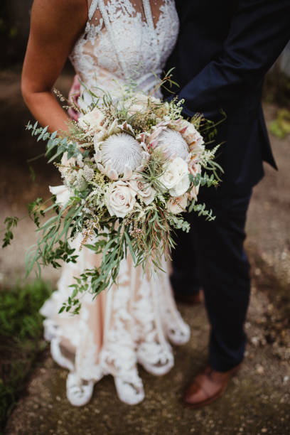 istock Bride and groom with protea wedding bouquet 1460041328