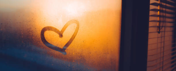 istock Heart drawn on a misty window during sunset 1460042472
