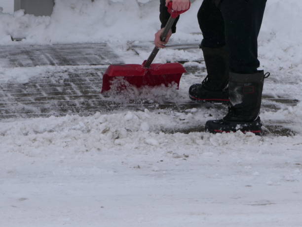 istock MAN SHOVELLING SNOW FROM FOOT PATH - CLOSE UP 1460042582