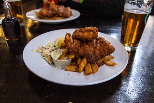 Traditional Fish and Chips plate served in the British style pub stock photo