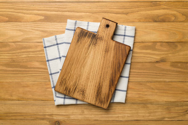istock Cutting board with towel on wooden background, top view 1460044885