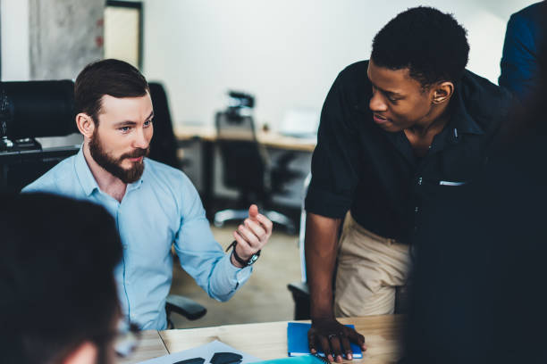 istock Confident male explaining project to partners in office 1460047609