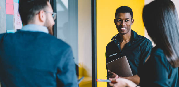 istock Happy African American worker discussing project with partners 1460047727