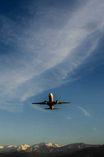 istock The plane takes off, blue sky on the background, mountains 1460047836