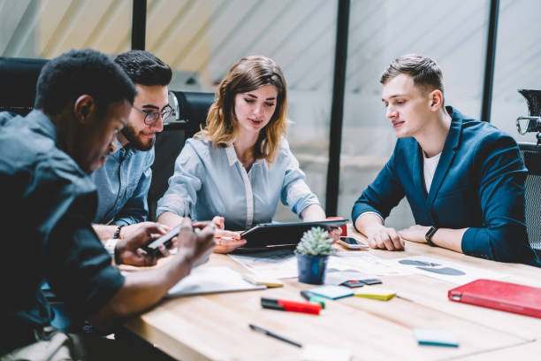 istock Young female explaining data to diverse coworkers 1460047919
