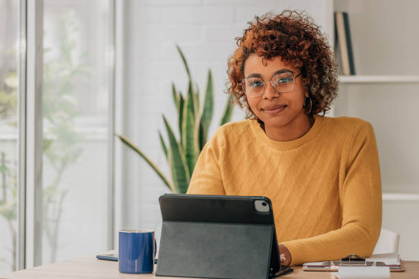 istock smiling girl with laptop working at home 1460048586