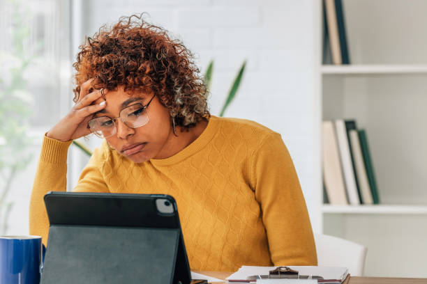 istock stressed girl with bill and laptop at home 1460049162