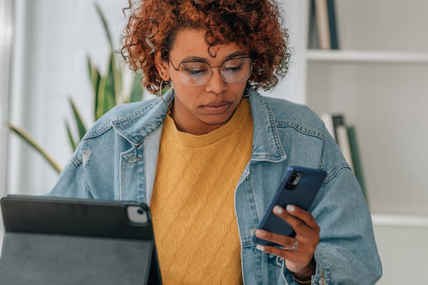 istock girl at home watching with mobile phone and computer 1460049219