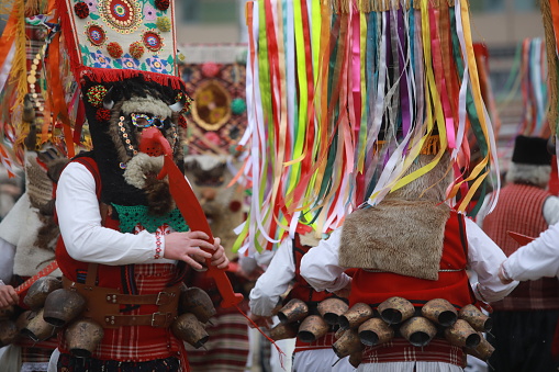 Pernik, Bulgaria - January 27, 2023: International masquerade festival Surva in Pernik, Bulgaria. People with mask called Kukeri dance and perform to scare the evil spirits.