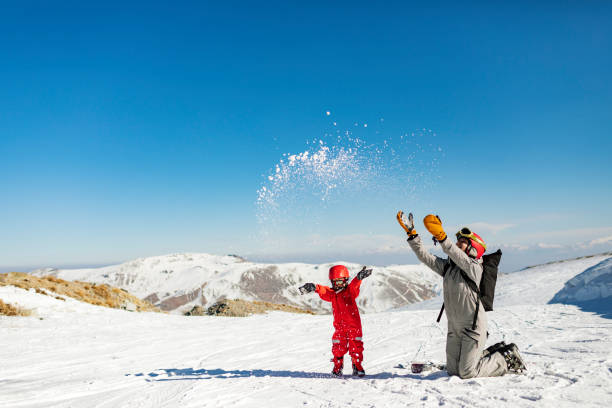 Mother with little son skiing at ski resort