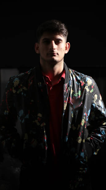 istock Young man at desk with black background 1460056815