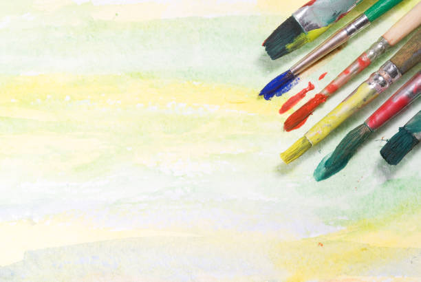 Paintbrushes on watercolor paper with copy space