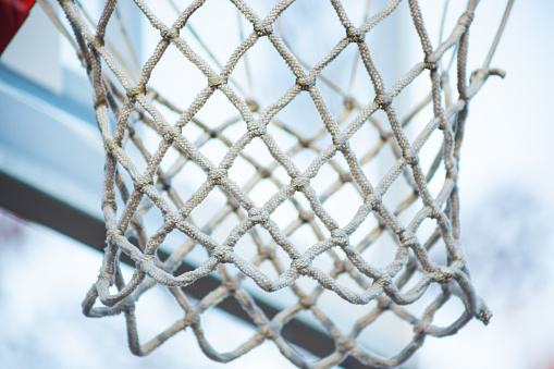 A view of the net on a basketball hoop.