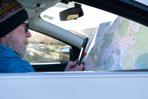 istock Senior man using his phone while sitting in a car 1460060511