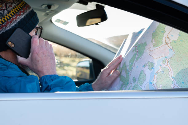 istock Mature man using his phone while sitting in a car 1460060531