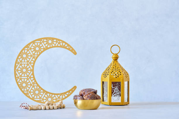 istock Ramadan kareem background . Golden Ramadan half moon decor with lantern, Islamic rosary beads and dates fruit. 1460062598