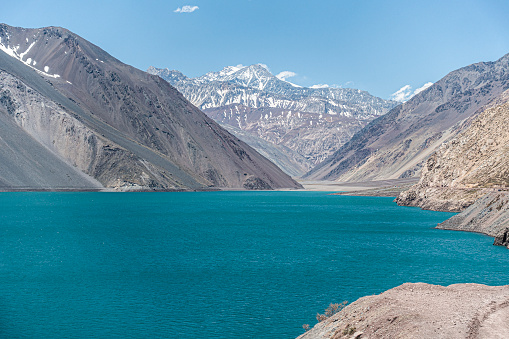 The stunning turquoise waters of El Yeso Reservoir, completed in 1968, with some of the Andes mountains behind. This reservoir contains much of the water which is used in Santiago, Chile.