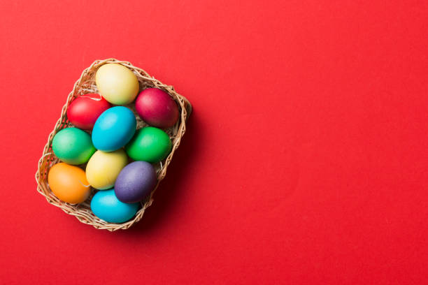 istock Multi colors Easter eggs in the woven basket on colored background . Pastel color Easter eggs. holiday concept with copy space 1460063830