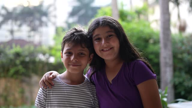 Portrait of happy islamic siblings at home