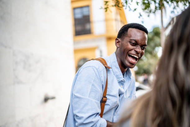 istock Young man laughing on a conversation outdoors 1460067434