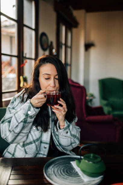 istock Woman drinking herbal tea for getting better health 1460067801