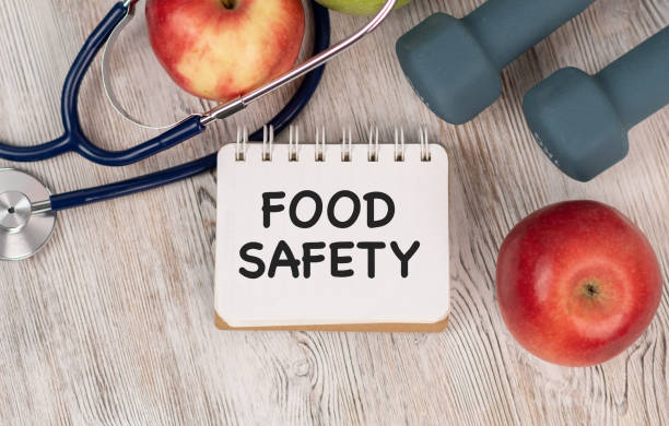 istock Food Safety Text Over Chopping Board Surrounded With Organic Fresh Vegetables 1460068452